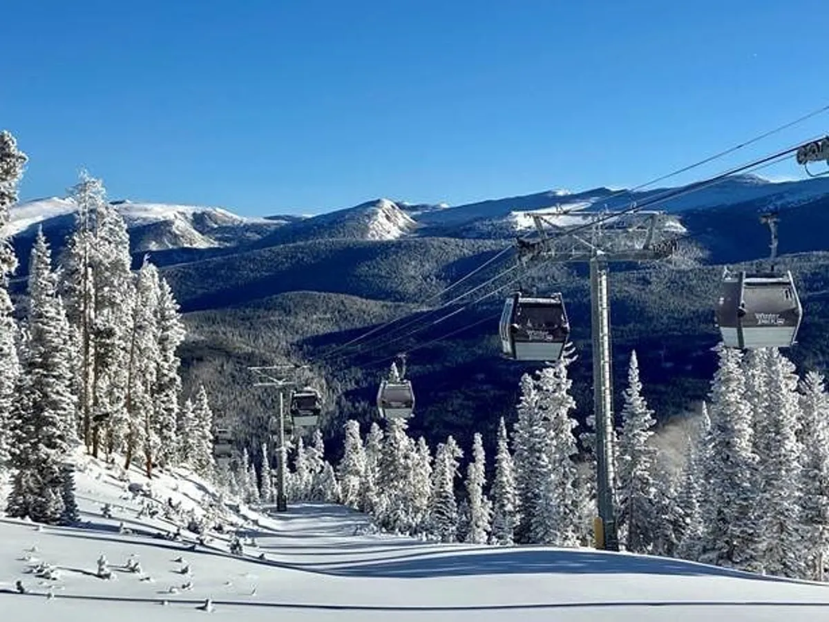 A stunning winter landscape with snow-capped mountains in the background, gondolas gliding overhead, and pristine ski slopes below. The scene is lively yet serene, evoking the exhilaration of mountain sports and scenic rides.